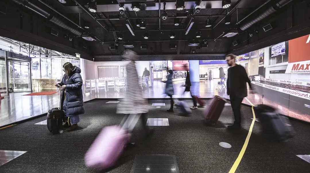Människor i rörelse i en simulerad flygplatsmiljö.